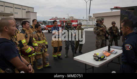 U.S. Marines and firefighters from Marine Corps Air Station Iwakuni and Japan Ground Self-Defense Force soldiers attend an after-action report to discuss performance during a chemical exposure drill as part of exercise Active Shield at MCAS Iwakuni, Japan, Oct. 18, 2017. Active shield is an annual exercise that tests the abilities of U.S. and Japanese forces to work alongside each other to protect and defend the air station and other U.S. assets in the region. (U.S. Marine Corps photo by Lance Cpl. Stephen Campbell) Stock Photo