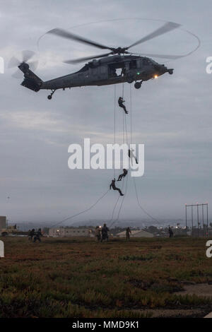 IMPERIAL BEACH, Calif. (March 13, 2018) Students, assigned to Explosive Ordnance Disposal Training and Evaluation Unit (EODTEU) 1, rappel from an MH-60S Sea Hawk helicopter, assigned to the 'Eightballers' of Helicopter Sea Combat Squadron (HSC) 8, during Tactical Training Course (TTC) basic air mobility training.  TTC is the final course in the Navy EOD pipeline. (U.S. Navy Stock Photo