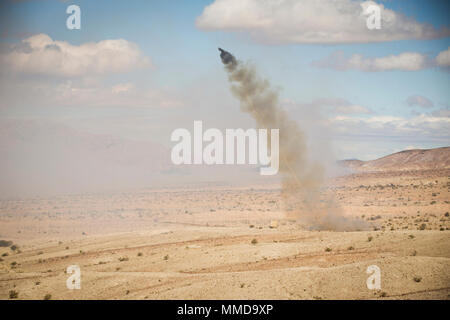 A U.S. Marine Corps M58 Mine Clearing Line Charge (MICLIC) fires a ...