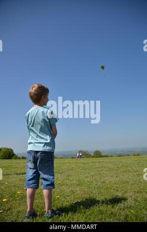 Boy flying a kite on a sunny day at Dunstable Downs Stock Photo