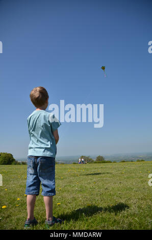 Boy flying a kite on a sunny day at Dunstable Downs Stock Photo