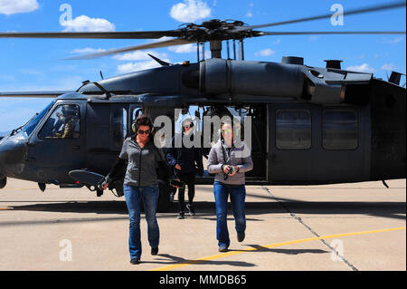 U.S. Air Force spouses exit an HH-60G Pavehawk during the 563rd Rescue Group’s annual Spouse Appreciation Day at Davis-Monthan Air Force Base, Ariz., March 17, 2018. This year’s celebration provided HH-60 and HC-130J Combat King II orientation flights to 563rd RQG spouses. (U.S. Air Force Stock Photo