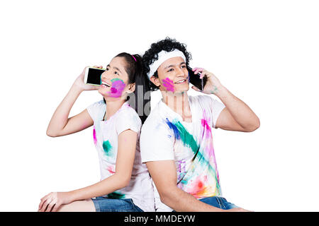 Happy Two Young Friend Together Holi festival Talking Mobile-phone Enjoying Stock Photo