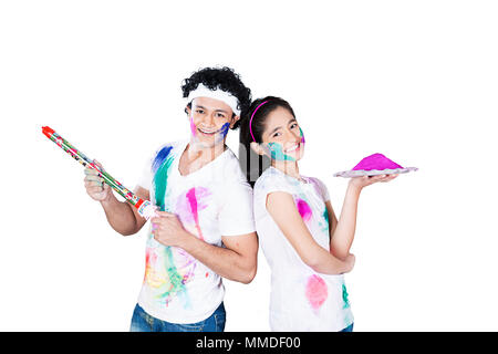 Two Young Friend playing colours with pichkari Holi Festival Celebrating Stock Photo