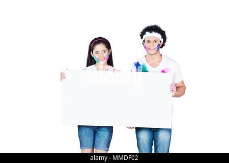 Two Teenager Boy And Girl Friend holding Whiteboard Holi Celebration Stock Photo