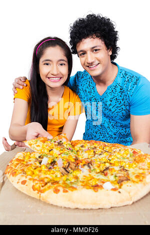 Two Young Teenage Friend Boy And Girl Eating Delicious Pizza Stock Photo