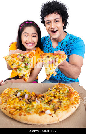 Two Teenage Friend Giving Tasty veg Pizza Offering Temptation Stock Photo