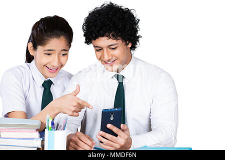Two High-School Friend Students Sharing Reading Text-Messaging Mobile Phone In-Class Stock Photo