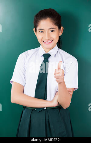 One Young School girl student Showing thumbs-up Success Education Classroom Stock Photo