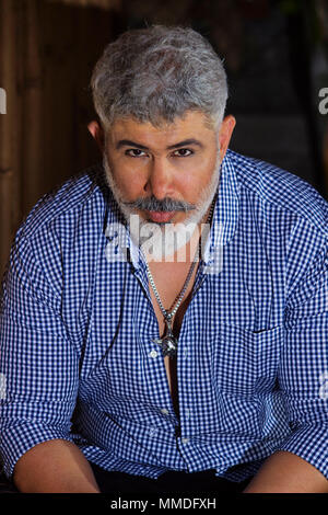 Close-up of man with grey hair and beard in smart casuals Stock Photo