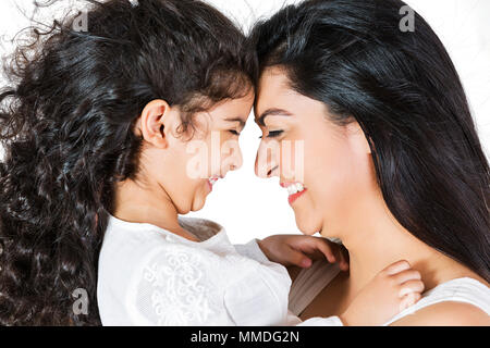 Happy mother and Little daughter touching Their foreheads Enjoying Playful Stock Photo