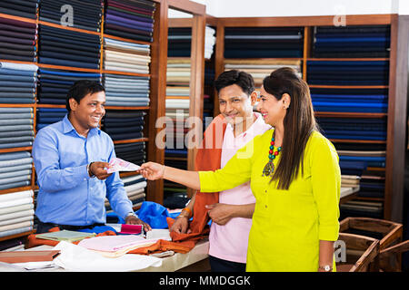 Salesman Selling Couple Customer Giving Rupees Bill Payment Shopping Clothes-Store Stock Photo