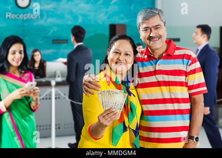 Two Old-Couple Customer Showing Money Banknotes At-bank Banking and Finance Stock Photo