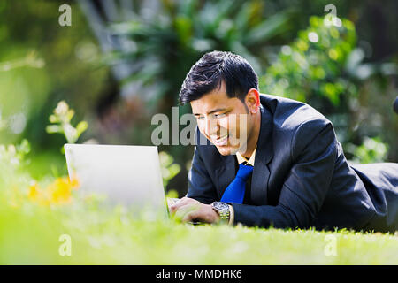 One Businessman Employee Lying Grass Resting Using Laptop Working In-garden Stock Photo