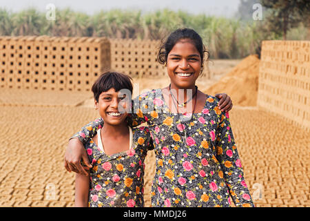 Two Rural Teenage Girls Factory Worker Together In Brick-Factory Village Stock Photo