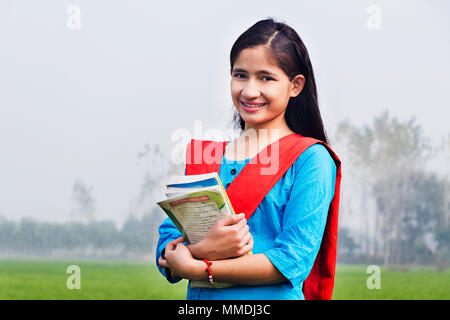 Rural Young Girl College Student Holding Books Education In-Farm Outdoors Stock Photo