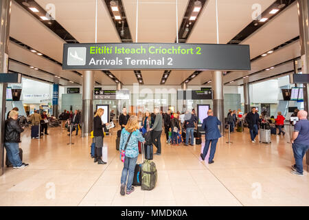 Dublin Airport, Ireland. Passengers Wait To Board A Flight Sit At ...