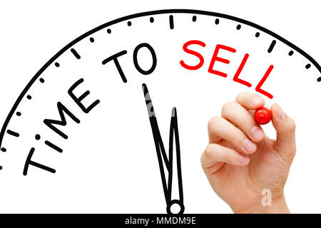 Hand writing Time to Sell concept with red marker on transparent wipe board. Stock Photo