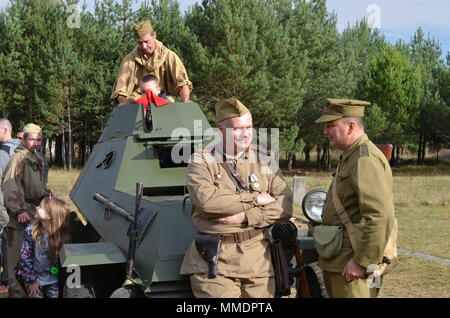 ZAGAN, Poland — Volunteers and historical reenactors from the Historical Association Big Red One Poland and U.S. Army Soldiers from 2nd Armored Brigade Combat Team, 1st Division, participate in a display of Army equipment for the Museum of Prisoner of War Camps, Zagan, Poland, Oct. 21. The museum invites the unit to support Polish-American relations, history and education regarding the Stalag Luft III Prisoner Camp Camp and World War II, since the unit was active in Europe during that time. Equipment displayed in the event are a M113, Armored Personnel Carrier M1 Abrams tank, M2 Bradley Fighti Stock Photo