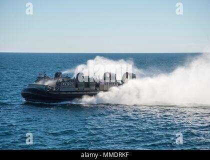 171021-N-RN119-0865 ATLANTIC OCEAN (Oct. 21, 2017) Landing craft air cushion (LCAC) 54, attached to Assault Craft Unit 4, cuts through the water to pick up cargo. LCAC 54 is on board the amphibious dock landing ship USS Gunston Hall (LSD-44) in support of exercise Bold Alligator 2017 (#BA17). Improving Navy-Marine Corps amphibious core competencies along with coalition, North Atlantic Treaty Organization (NATO) Allied and partner nations is a necessary investment in the current and future readiness of our forces. BA17 will take place Oct. 18 - 30, 2017, ashore along the eastern seaboard. (U.S. Stock Photo