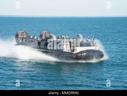 171021-N-RN119-0953 ATLANTIC OCEAN Landing craft air cushion (LCAC) 54, attached to Assault Craft Unit 4, cuts through the water to pick up cargo. LCAC 54 is on board the amphibious dock landing ship USS Gunston Hall (LSD-44) in support of exercise Bold Alligator 2017 (#BA17). Improving Navy-Marine Corps amphibious core competencies along with coalition, North Atlantic Treaty Organization (NATO) Allied and partner nations is a necessary investment in the current and future readiness of our forces. BA17 will take place Oct. 18 - 30, 2017, ashore along the eastern seaboard. (U.S. Navy photo by M Stock Photo