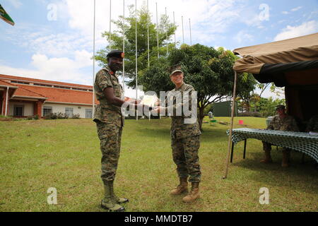 Gen. Nakibus Lakara, the base commandant of Camp Jinja, presents an appreciation award to Lieutenant Col. Karin Fitzgerald, the commanding officer of Special Purpose Marine Air-Ground Task Force-Crisis Response-Africa logistics combat element at Camp Jinja, Uganda, Oct. 13, 2017. SPMAGTF-CR-AF Marines deployed to conduct crisis-response and theater-security operations in Europe and Africa. (U.S. Marine Corps photo by Lance Cpl. Patrick Osino) Stock Photo