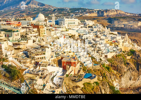 Panoramic view of Thira town on the very brink of a precipice in the evening, Santorini, Greece Stock Photo