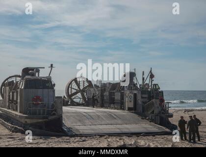 171022-N-RN119-168 ATLANTIC OCEAN (Oct. 22, 2017) The crew of Landing craft air cushion (LCAC) 53, attached to Assault Craft Unit 4, prepares to pick up cargo. LCAC 53 is on board the amphibious dock landing ship Gunston Hall (LSD-44) in support of exercise Bold Alligator 2017 (BA17). Improving Navy-Marine Corps amphibious core competencies along with coalition, North Atlantic Treaty Organization (NATO) Allied and partner nations is a necessary investment in the current and future readiness of our forces. BA17 will take place Oct. 18 - 30, 2017, ashore along the eastern seaboard. (U.S. Navy ph Stock Photo