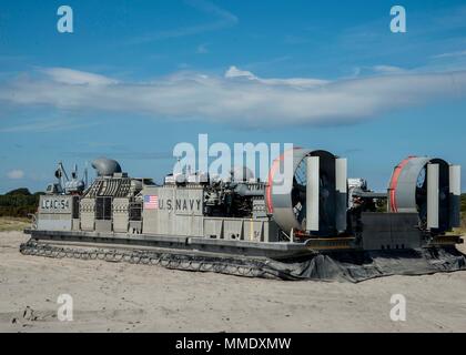 171022-N-RN119-202 ATLANTIC OCEAN (Oct. 22, 2017) Landing craft air cushion (LCAC) 54, attached to Assault Craft Unit 4, arrives on the beach to pick up cargo. LCAC 54 is on board the amphibious dock landing ship Gunston Hall (LSD-44) in support of exercise Bold Alligator 2017 (BA17). Improving Navy-Marine Corps amphibious core competencies along with coalition, North Atlantic Treaty Organization (NATO) Allied and partner nations is a necessary investment in the current and future readiness of our forces. BA17 will take place Oct. 18 - 30, 2017, ashore along the eastern seaboard. (U.S. Navy ph Stock Photo