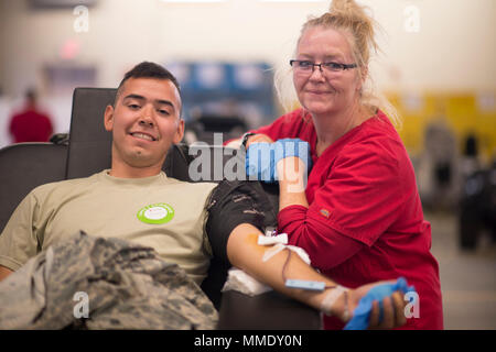 https://l450v.alamy.com/450v/mmdy0n/us-air-force-airman-ramon-tinajero-left-a-crew-chief-with-the-158th-fighter-wing-poses-with-pamela-mccarthy-american-red-cross-collection-specialist-during-an-american-red-cross-blood-drive-held-at-the-vermont-air-national-guard-base-south-burlington-vt-oct-15-2017-the-annual-junior-enlisted-council-blood-drive-is-a-way-for-the-airmen-of-the-158fw-to-give-back-to-the-community-they-serve-us-air-national-guard-photo-by-senior-airman-jon-alderman-mmdy0n.jpg