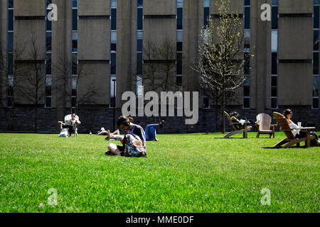 Philadelphia, PA, USA - April 23, 2018: Students lounge on green space in Philadelphia's University City neighborhood. Stock Photo