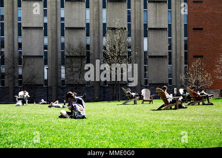 Philadelphia, PA, USA - April 23, 2018: Students lounge on campus green space in Philadelphia's University City neighborhood. Stock Photo