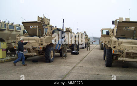 Soldiers and Army Civilian employees prepare vehicles for Medium Mine Protected Vehicle (MMPV) Type II operational testing execution. (Photo Credit: Maj. Jason E. Carney, Test Officer, Maneuver Support and Sustainment Test Directorate, U.S. Army Operational Test Command Public Affairs) Stock Photo