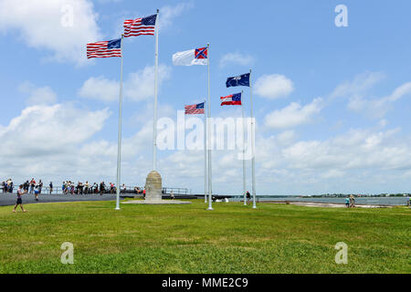 American Flags - Six flags, a 50-star United States flag and five historic flags, flying on blue sky over Fort Sumter, Charleston, South Carolina, USA Stock Photo