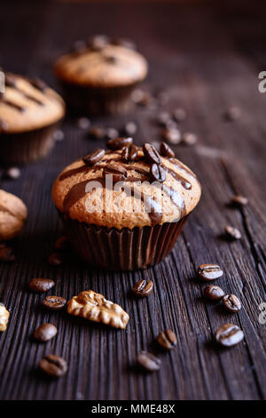 Coffee muffins with grated walnut and topped with chocolate Stock Photo