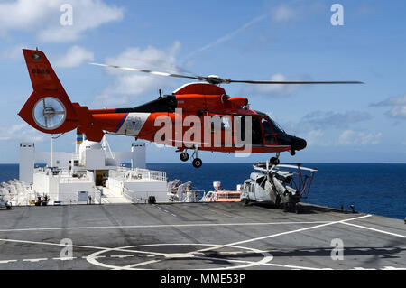 1710125-N-PG340-204 CARIBBEAN SEA (Oct. 25, 2017) A Coast Guard Dolphin HH-65C Helicopter conducts deck landing qualifications on the Military Sealift Command hospital ship USNS Comfort (T-AH 20). Comfort is underway operating in the vicinity of Ponce, Puerto Rico. The Department of Defense is supporting the Federal Emergency Management Agency, the lead federal agency, in helping those affected by Hurricane Maria to minimize suffering and is one component of the overall whole-of-government response effort. (U.S. Navy photo by Mass Communication Specialist 2nd Class Stephane Belcher/Released) Stock Photo