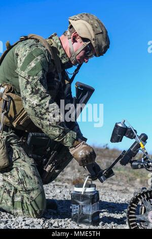 Explosive Ordnance Disposal Technician 2nd Class William Orndorff, from Auburn, Kentucky, stationed with Explosive Ordnance Disposal Mobile Unit One, attaches a detonation device to an ordnance disposal robot on San Clemente Island during exercise Dawn Blitz. Dawn Blitz is a scenario-driven exercise designed to train and integrate Navy and Marine Corps units by providing a robust training environment where forces plan and execute an amphibious assault, engage in live-fire events, and establish expeditionary advanced bases in a land and maritime threat environment to improve naval amphibious co Stock Photo
