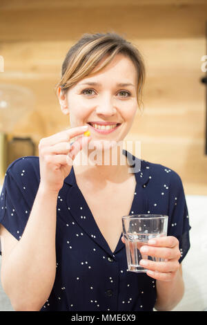 WOMAN TAKING MEDICATION Stock Photo