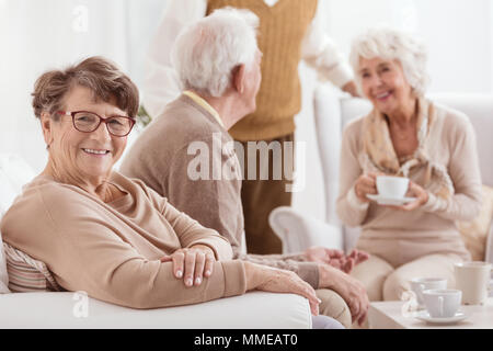 Happy elederly people spending time together, relaxing at home Stock Photo