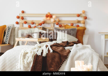 Close-up photo of a bed with blankets and pillows Stock Photo