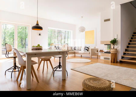 Wooden white dining table in modern designed living room Stock Photo