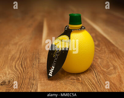 CHISINAU, MOLDOVA - May 08, 2018: Casa Rinaldi, Italian product Lemon Juice Condiment in a bottle. On a wooden table background Stock Photo