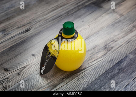 CHISINAU, MOLDOVA - May 08, 2018: Casa Rinaldi, Italian product Lemon Juice Condiment in a bottle. On a wooden table background Stock Photo