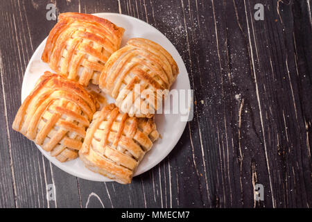 Cookies and sweet pastries with cross wired lines in white plate. Top view Stock Photo