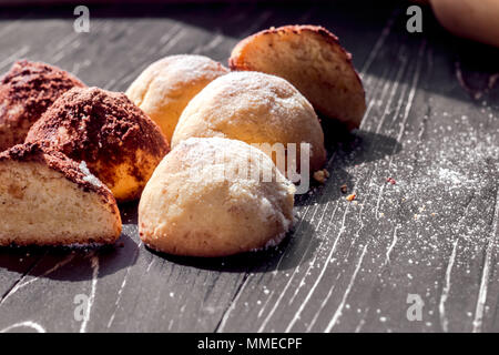 Homemade Cookies with chocolate truffle on black wood with rolling ping. Stock Photo
