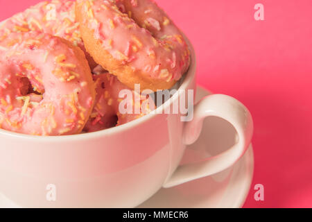A teacup of mini donuts Stock Photo