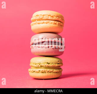 Stack of three macarons on a pink background Stock Photo