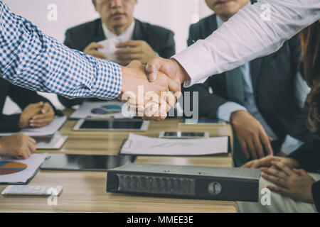 Asian businessman shaking hands in conference room. Business people shaking hands agreement concept. Stock Photo