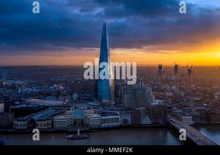 London city night skyline.  A sunset cityscape of London featuring The Shard skyscraper, River Thames and London Bridge