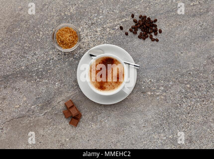 A Mocha coffee, shot on a stone worktop, with coffee beans and chocolate. Stock Photo